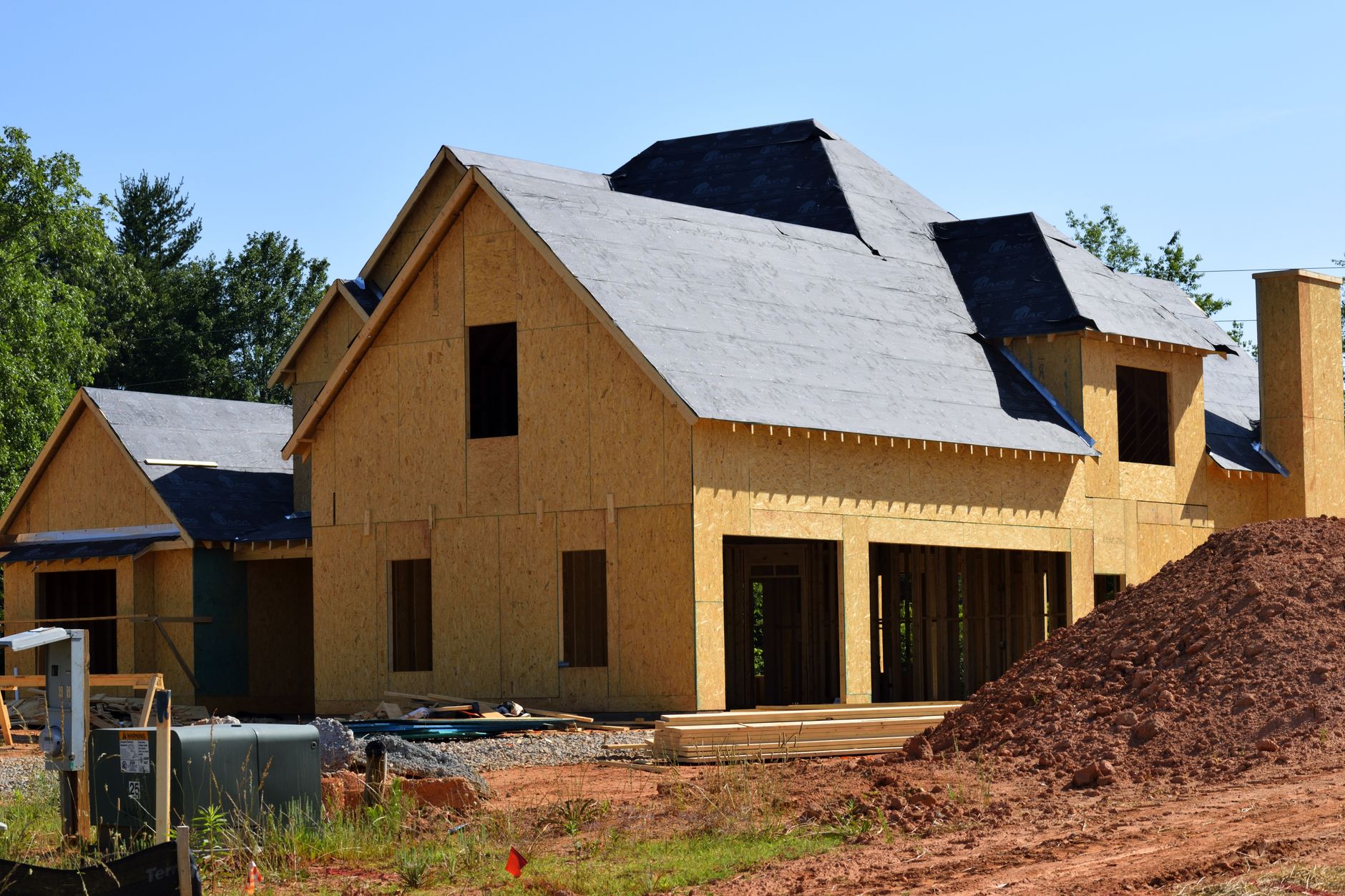 House under construction with framing and roof sheathing